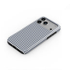 Navy Houndstooth phone case lying flat at an angle, showing the raised edge profile