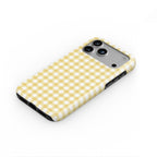 Butter Yellow Gingham phone case — steep top-down angle, case lying face up